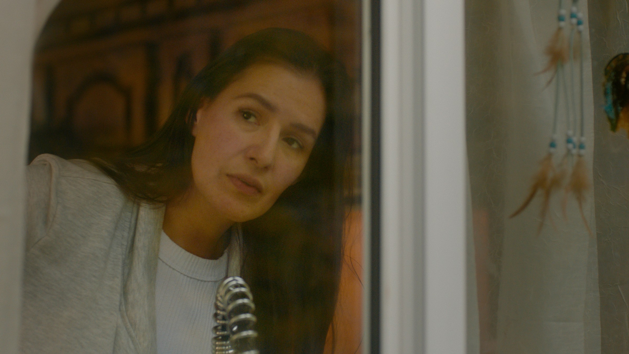 A woman leans around an open refrigerator door — Communikit