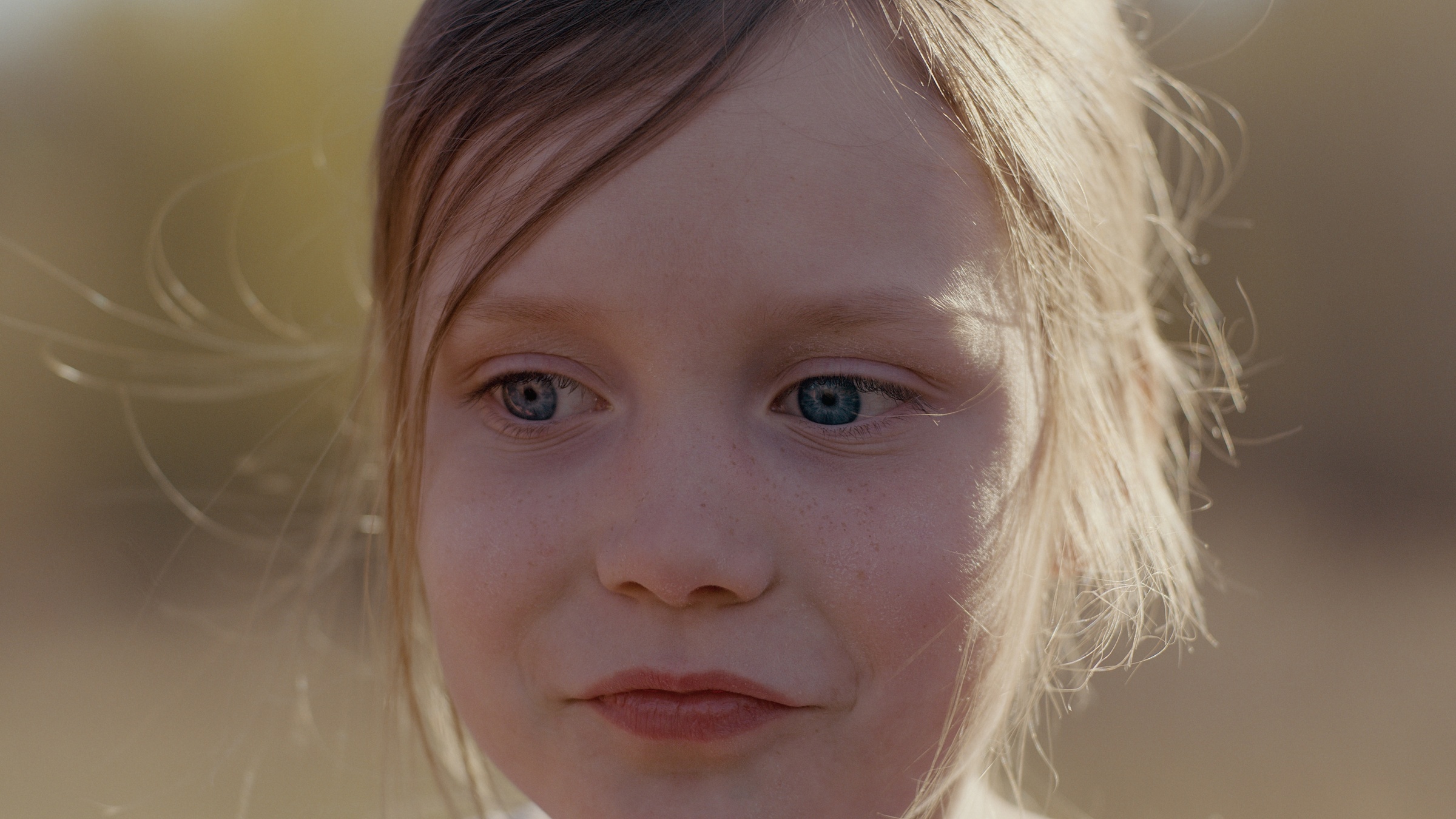 Close-up of a young child in warm outdoor light — Home Fire