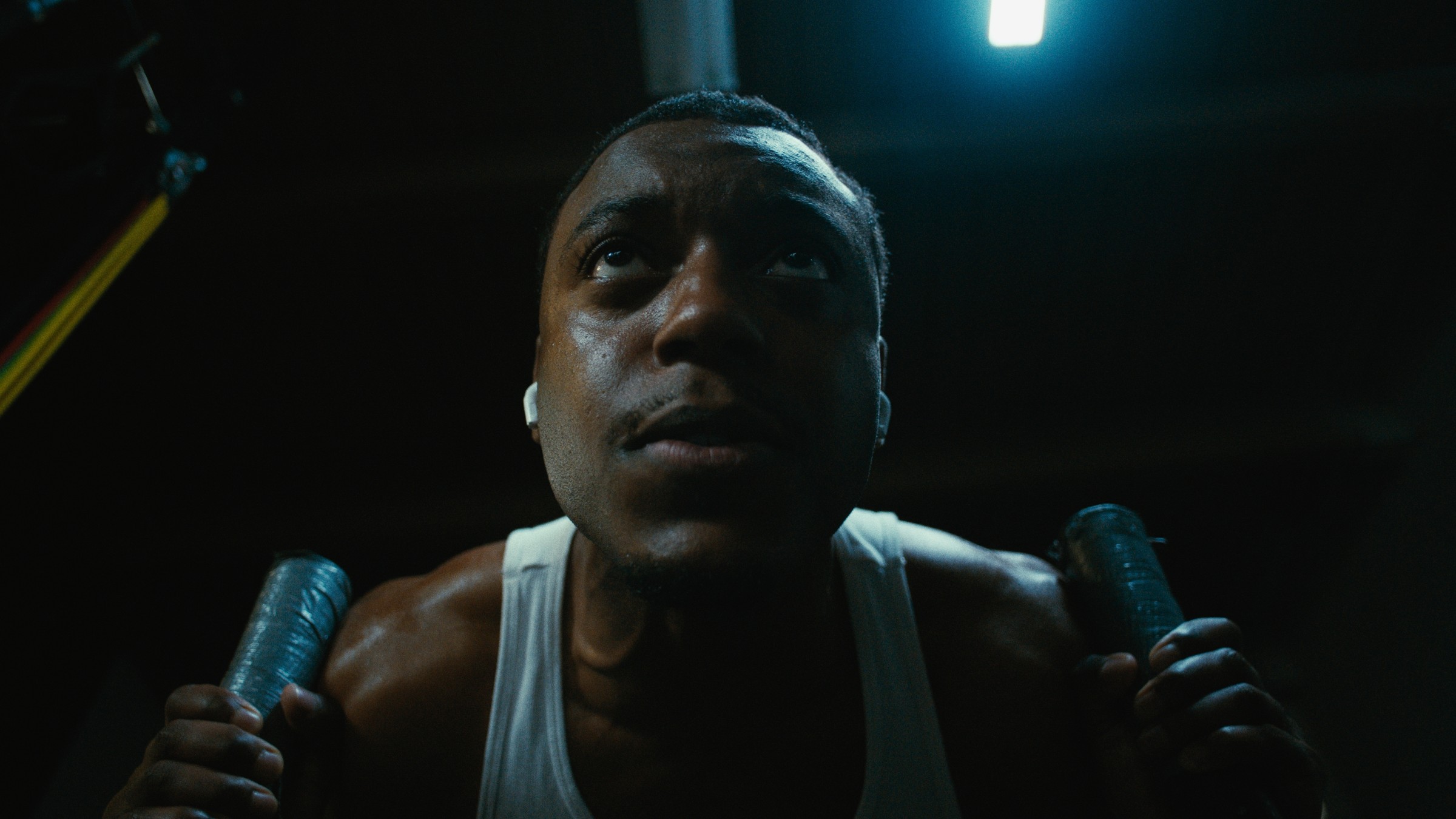 Close-up of a boxer training beneath a cool overhead light — Kinetic