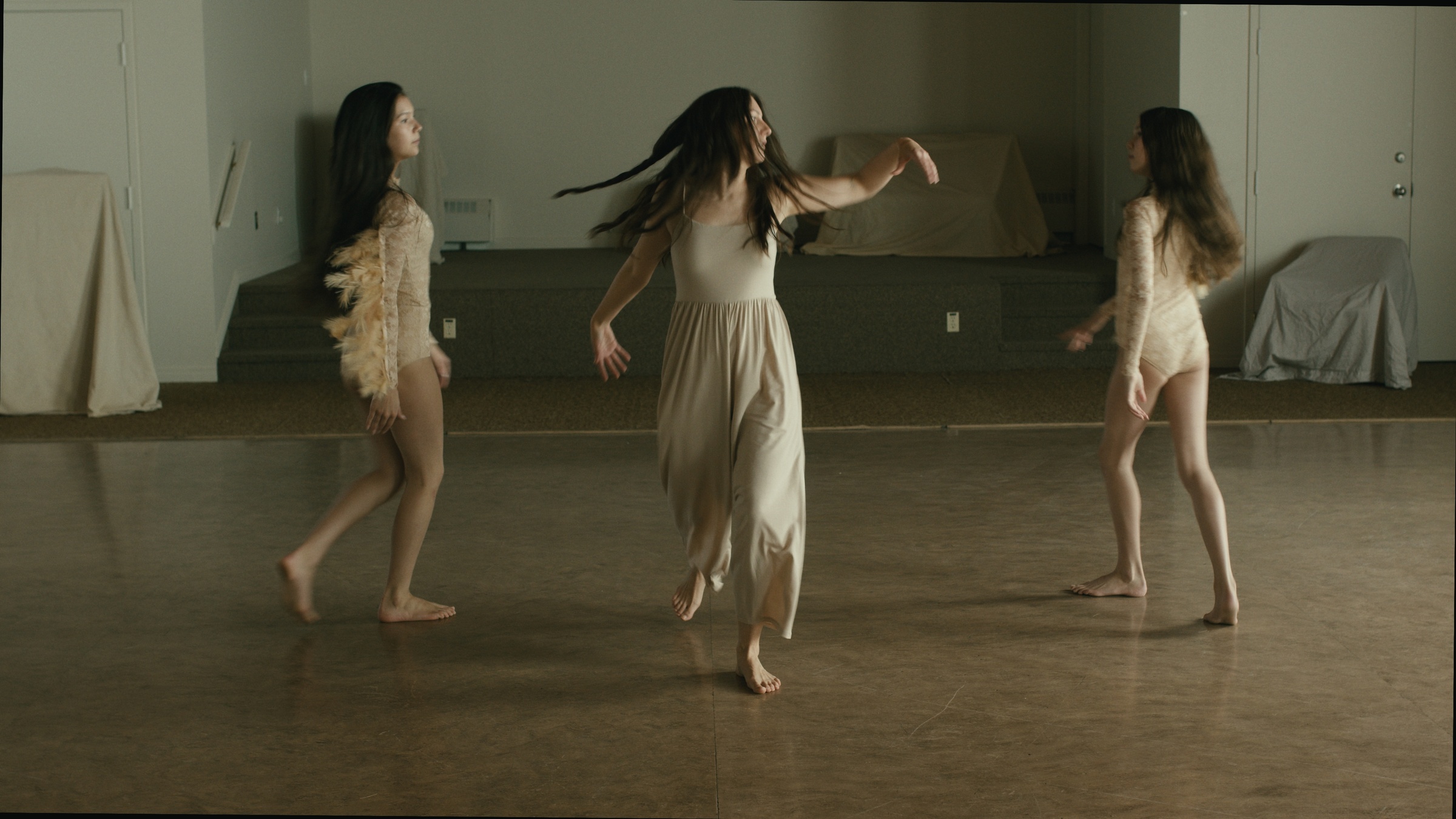 Three women dance together on a wooden floor — Let Go