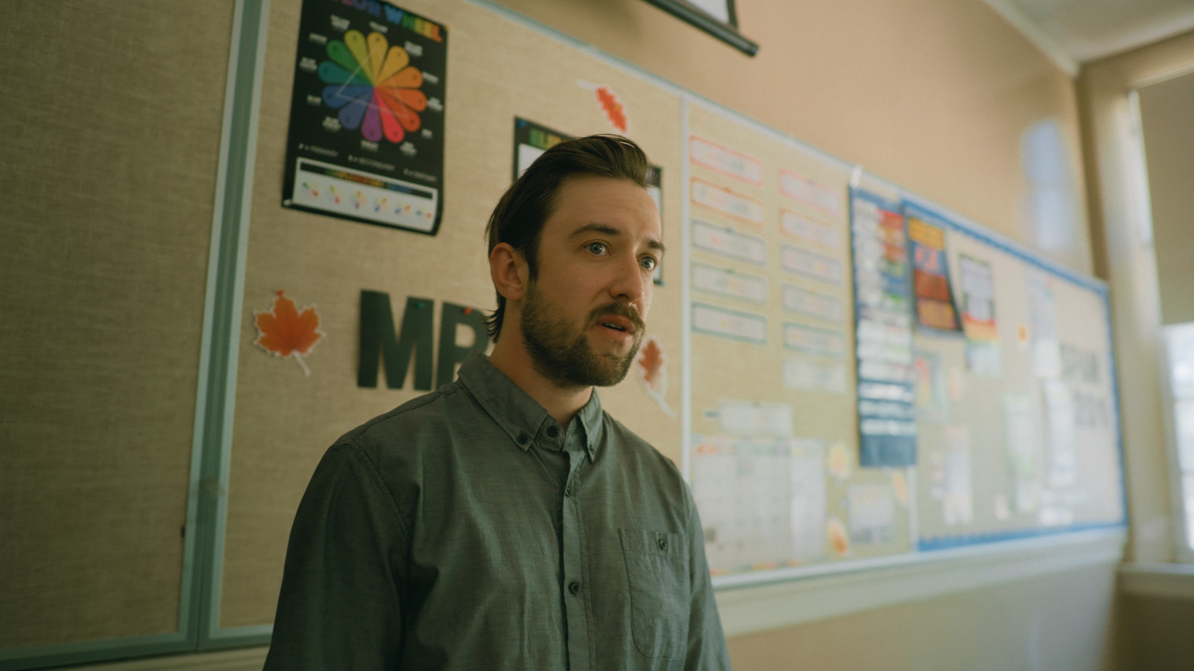 A man stands at a classroom doorway — Little Fangs