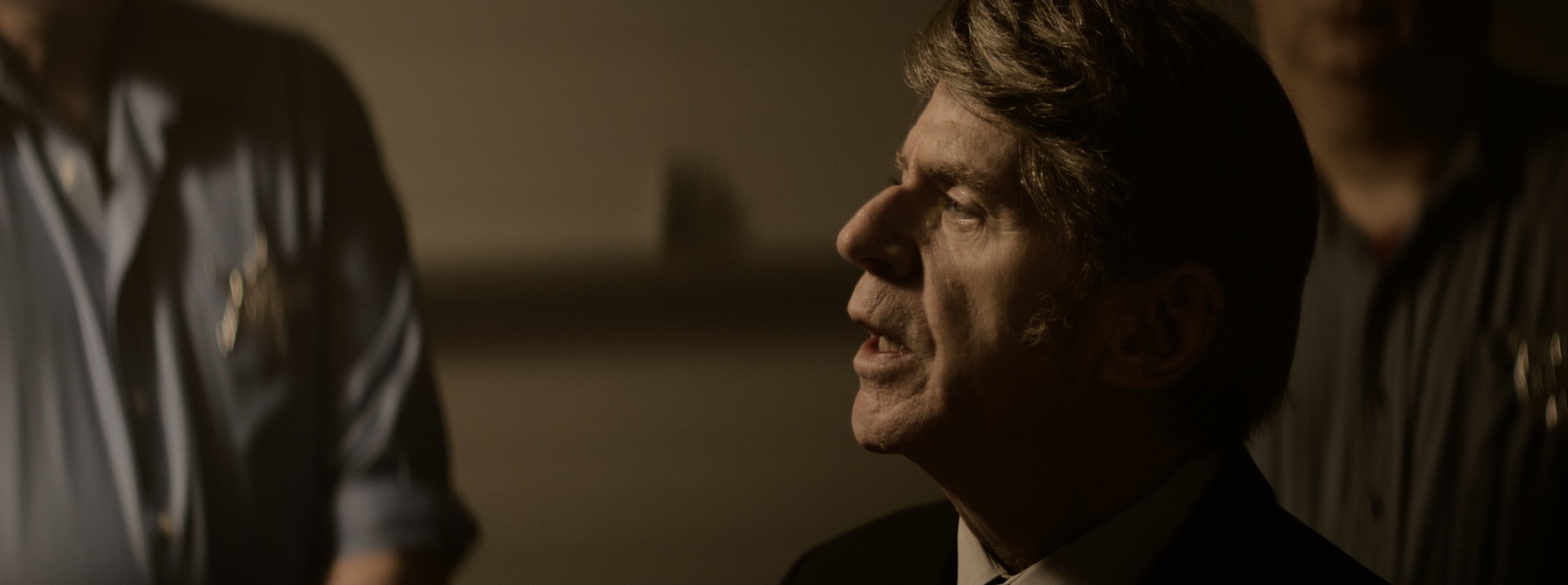 An older man looks up toward someone beside him — Markings of Murder