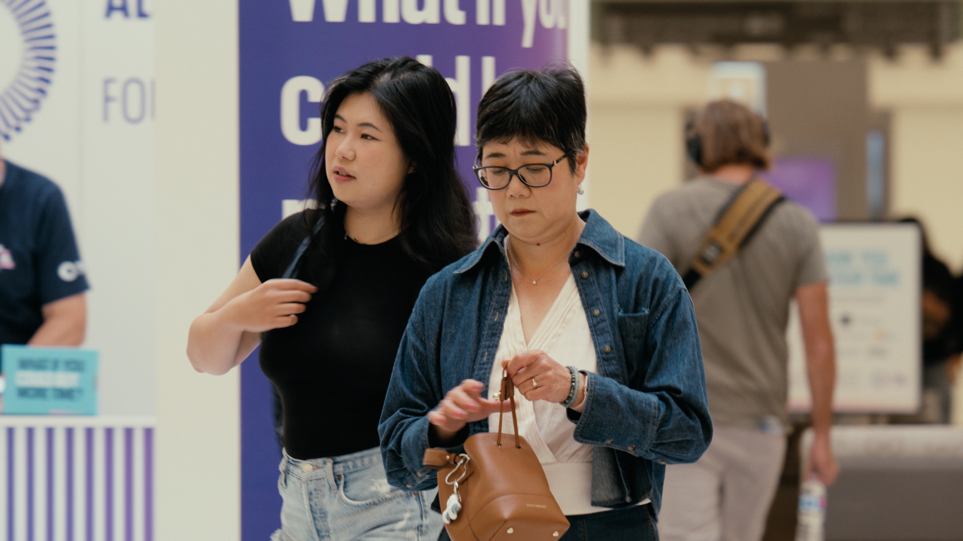 Two women look around a retail display in a shopping centre — Time Store