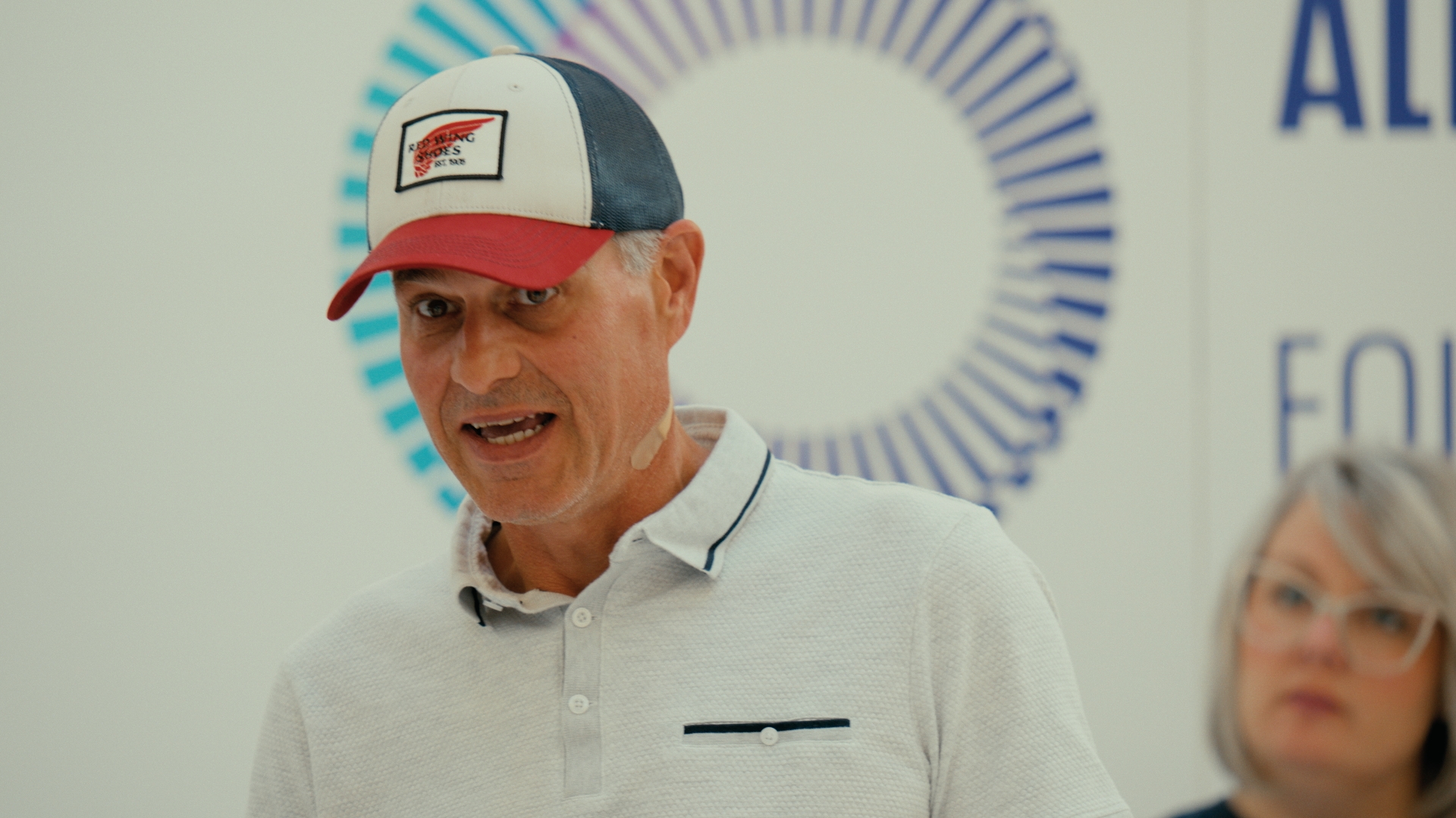 A man in a baseball cap speaks inside the installation — Time Store